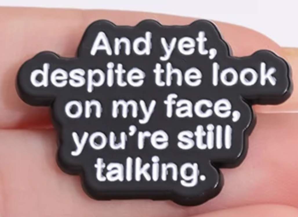 And yet despite the look on my face, you're still talking enamel pin badge