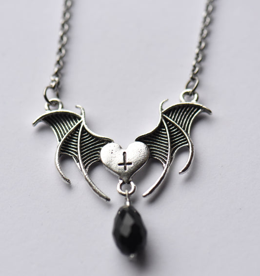 Bat wing and heart necklace on a 18 inch stainless steel chain