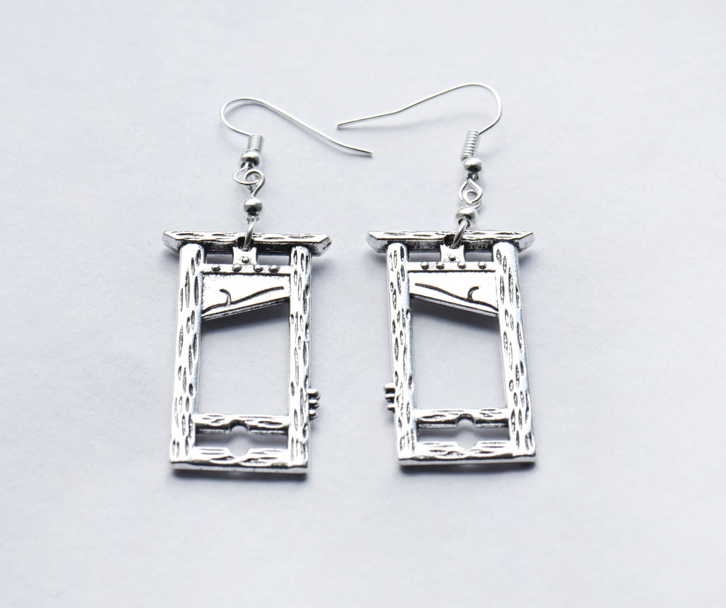 Large guillotine earrings on silver coloured ear wires